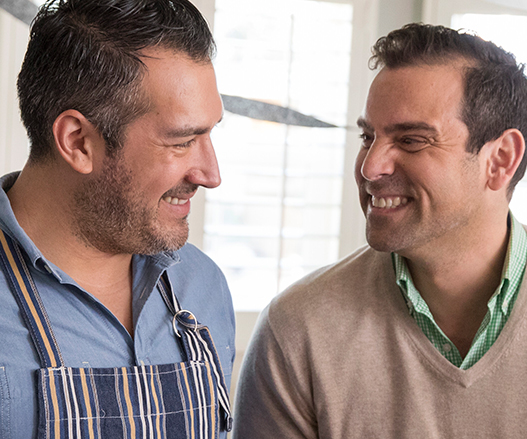 Two men smiling