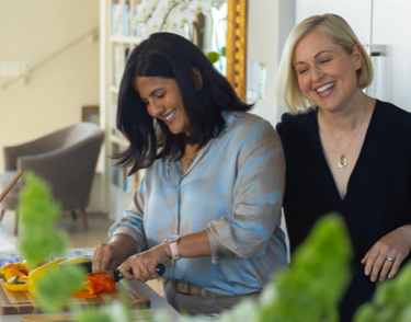 Two women preparing food in the kitchen