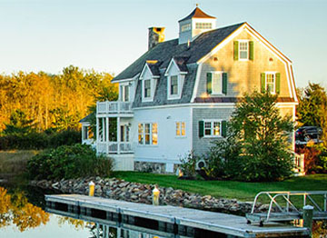 Article Image - A beautiful Dutch Colonial house on a lake. Learn what to ask before buying a second home.